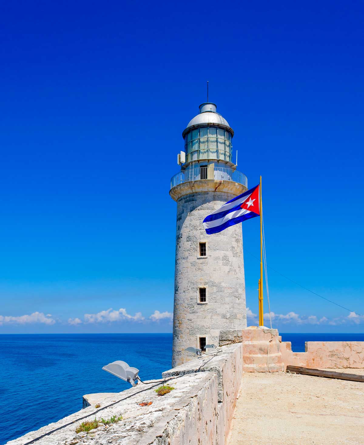old lighthouse with cuban flag