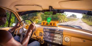 interior of an old taxi with a cuban driver