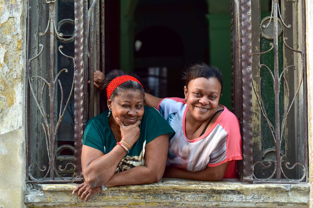 two smiling cuban women in window frame
