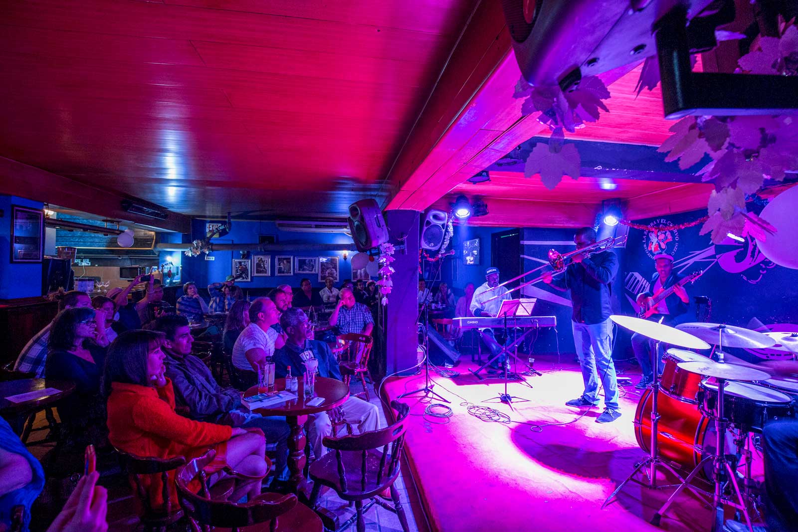 crowd watching jazz musicians perform at night club